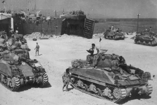 Shermans preparing to embark at Catania for Italy.