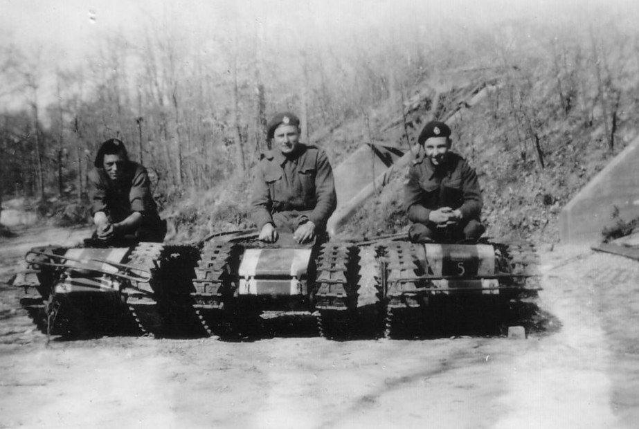 Men from 44th RTR on captured 'Beetle' tanks, photographed as they crossed the Siegfried Line. From left to right Walter Kosh, Commander. Dick Richardson - Gunner. Frank Garside - Driver. Picture courtesy of Dave Cornett.