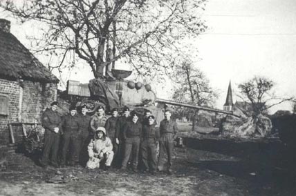 Men of 3rd/4th CLY (The Sharpshooters) next to a Sherman Firefly, in Stamproy, Holland, December 1944