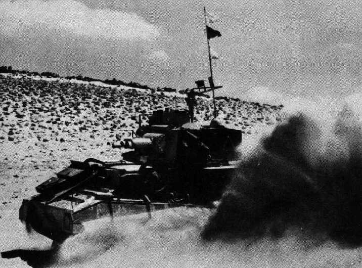 A Vickers MKVI Light Tank kicking up dust while on patrol in the desert.